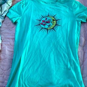 teal shirt with sun ,moon,and flowers
